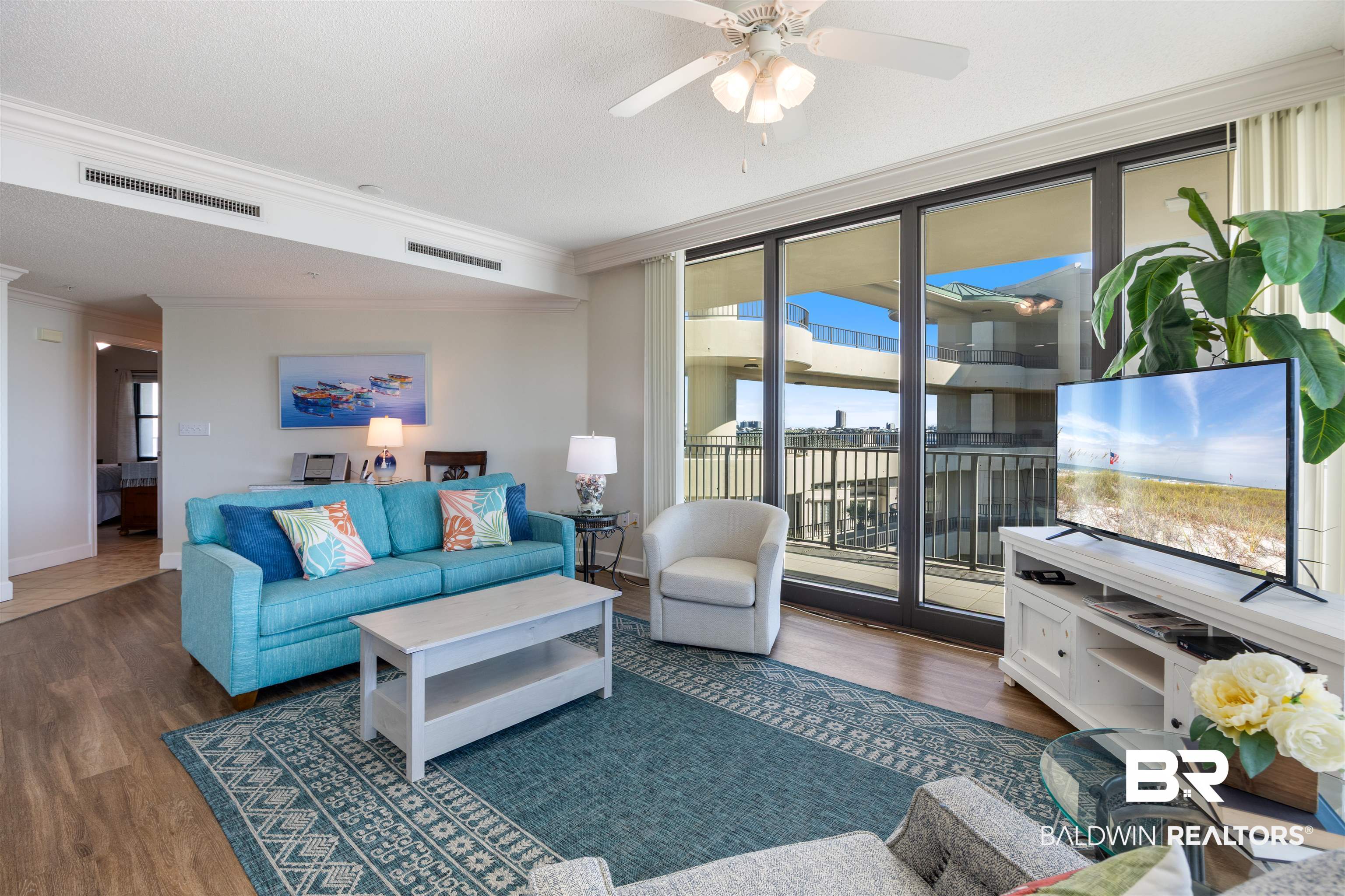 27580 Canal Road, Unit 1431 Orange Beach, AL 36561 - Photo 11 of 73 Living room with ornamental molding, wood finished floors, expansive windows, and ceiling fan
