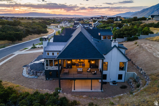 3247 South Mapleton Estates Drive Mapleton, UT 84664 - Photo 3 of 70 Back of house at dusk featuring a chimney, a standing seam roof, and a deck with mountain view