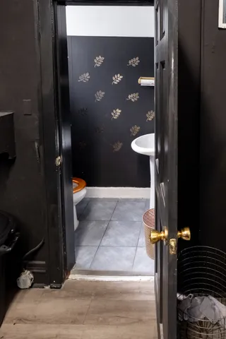 a living room with furniture flat screen tv and wooden floor