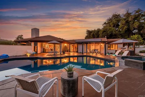 a front view of a house with outdoor seating