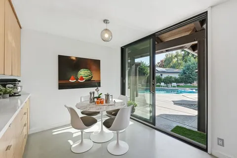 a view of a hallway with wooden floor and windows