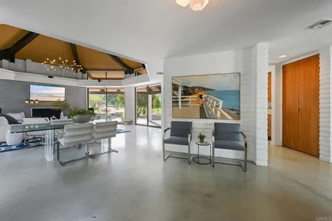 a room with a bed and large window with balcony view