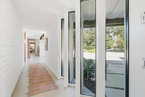 a bedroom with a bed and glass door
