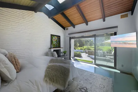 a living room with patio furniture and a potted plant