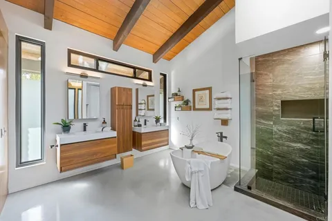 a bathroom with a shower and a sink