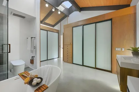 a bed sitting in a bedroom next to a window