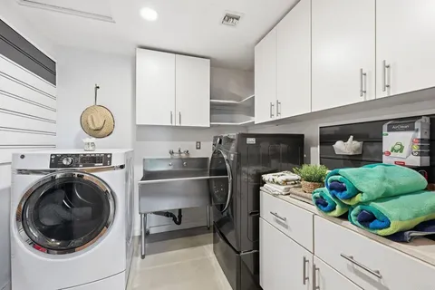 a view of a swimming pool with lounge chairs in patio