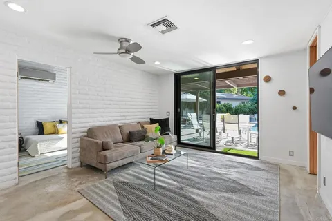 a view of a swimming pool with lounge chairs in patio