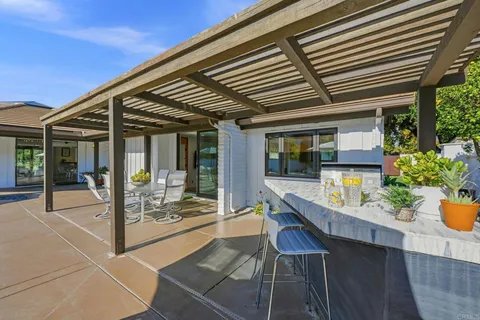 a view of a house with backyard patio and swimming pool