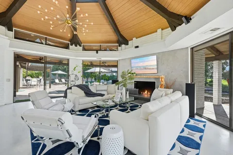 a living room with furniture a fireplace and a table