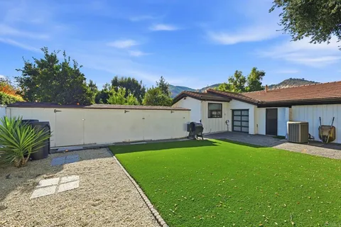 a view of a patio with couches table and chairs and potted plants
