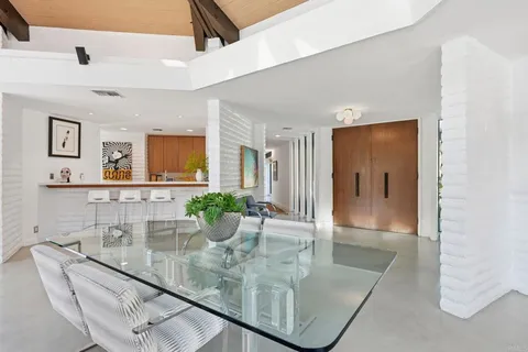 a hallway with table and chairs