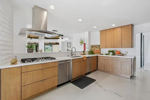 a kitchen with a sink stove and cabinets