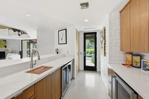 a kitchen with a sink and a stove top oven