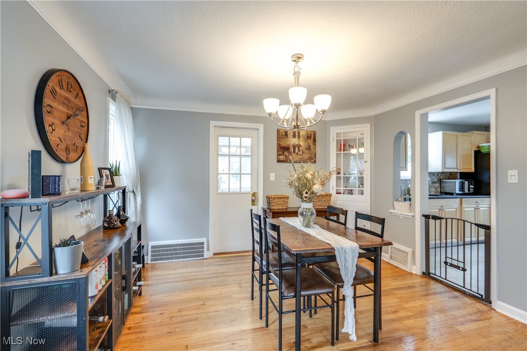 1375 Gordon Road Lyndhurst, OH 44124 - Photo 9 of 34 Dining room featuring a chandelier and light wood-style flooring