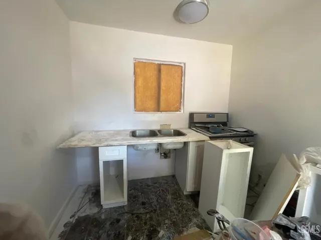 a room with a sink cabinets and window
