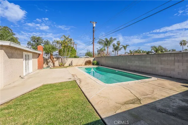 a backyard of a house with table and chairs