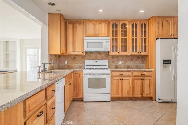 a kitchen with cabinets appliances and a sink