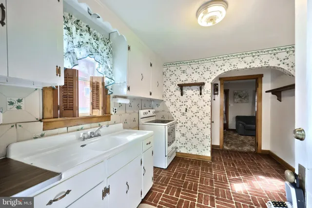 a kitchen with a stove top oven sink and cabinets