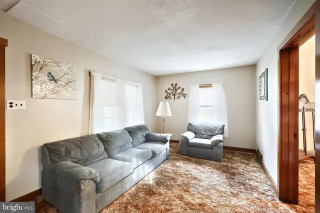 a living room with furniture and a lamp