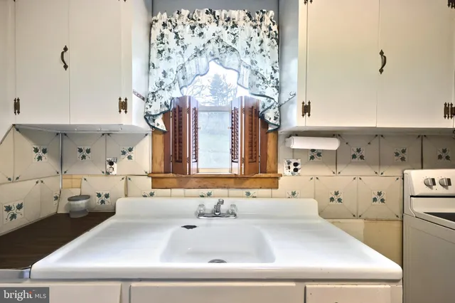 a bathroom with a bathtub and window
