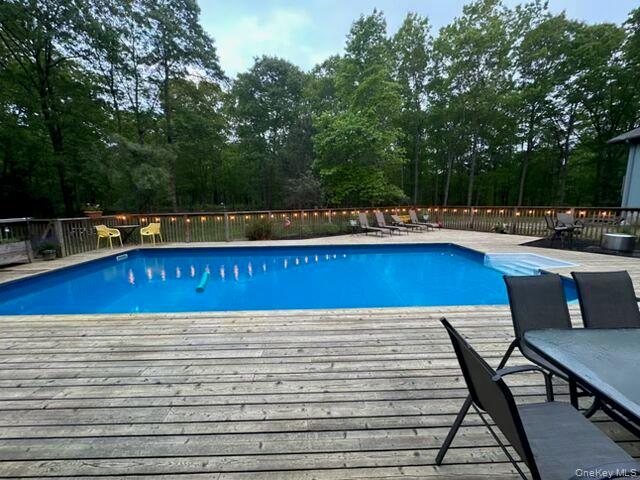 43 B Old Squires Road Hampton Bays, NY 11946 - Photo 11 of 12 a view of a swimming pool with sitting area