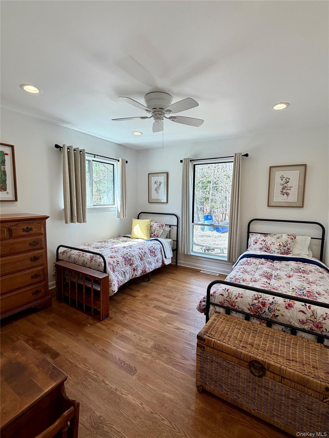 43 B Old Squires Road Hampton Bays, NY 11946 - Photo 2 of 12 a bedroom with a large bed and a chandelier