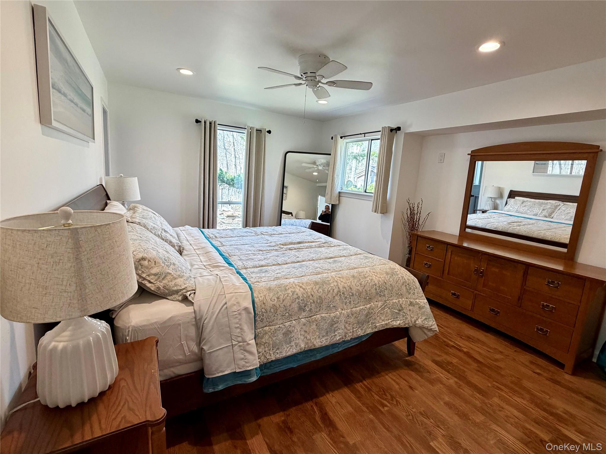 43 B Old Squires Road Hampton Bays, NY 11946 - Photo 5 of 12 a bedroom with a bed and window