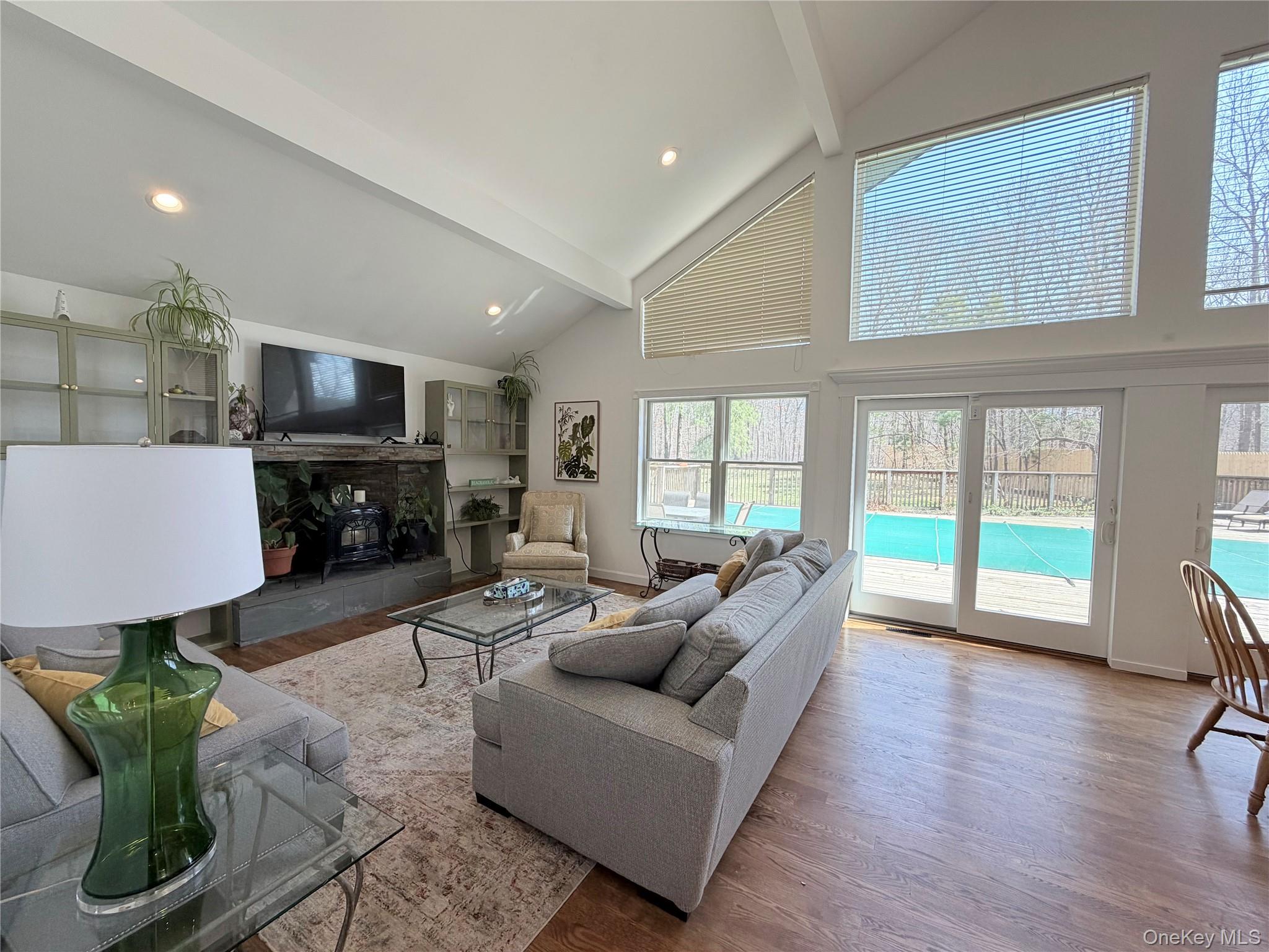 43 B Old Squires Road Hampton Bays, NY 11946 - Photo 9 of 12 a living room with furniture and a fireplace