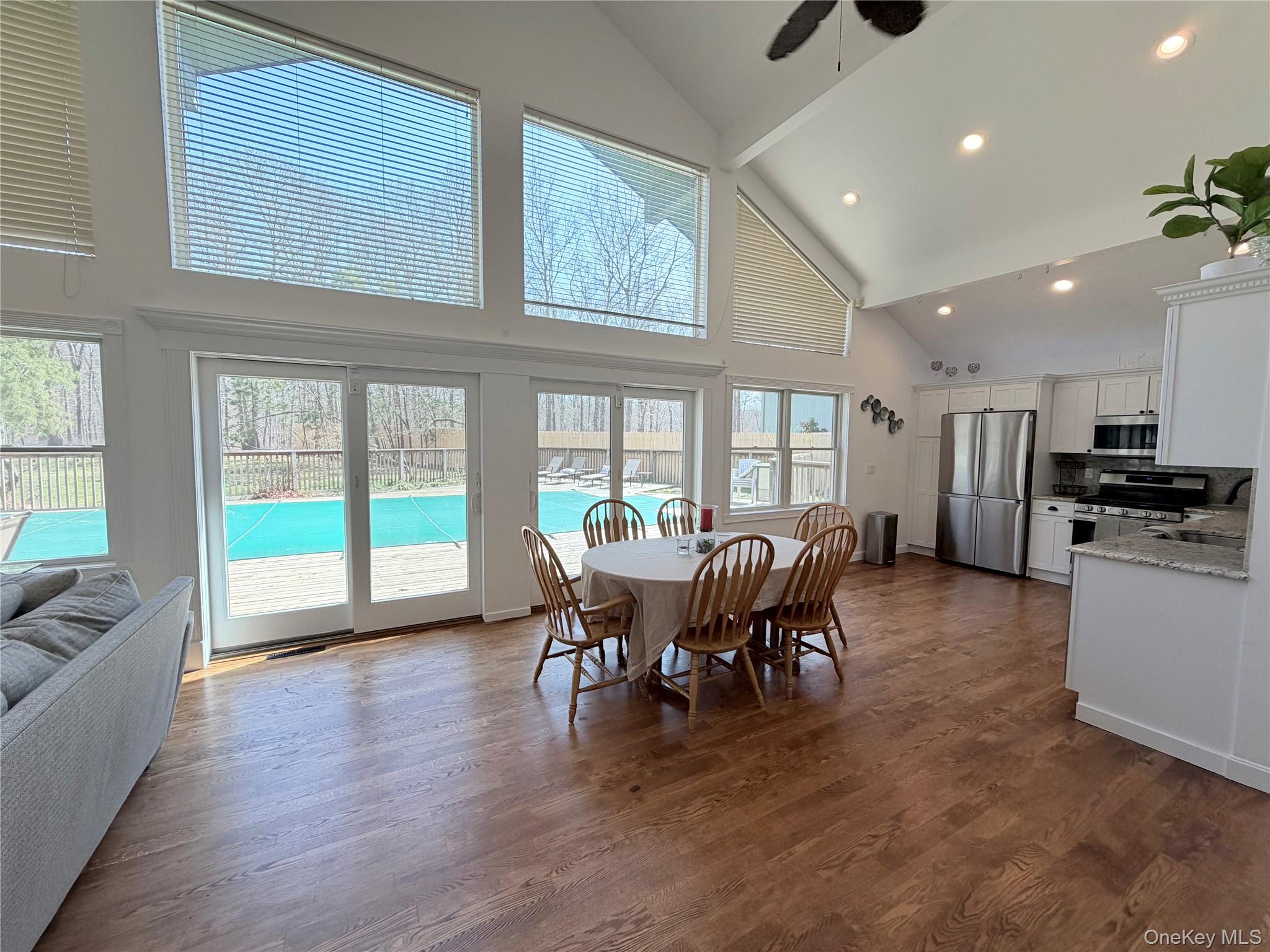 43 B Old Squires Road Hampton Bays, NY 11946 - Photo 10 of 12 a view of a dining room with furniture window and wooden floor