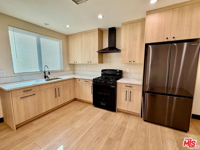 a kitchen with a refrigerator sink and cabinets