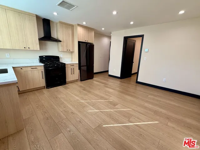 a kitchen with stainless steel appliances a refrigerator sink and microwave