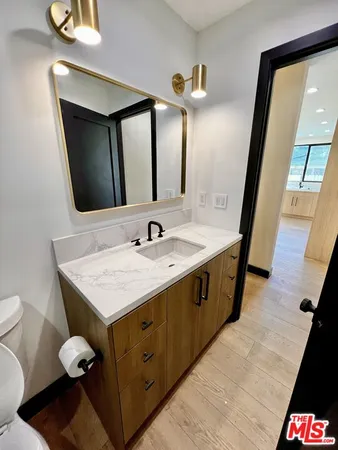 a bathroom with a sink a vanity and a mirror