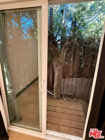 a view of balcony door and wooden floor