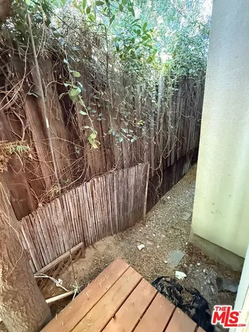a view of a backyard with wooden fence