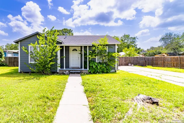 a view of a house with swimming pool and sitting area