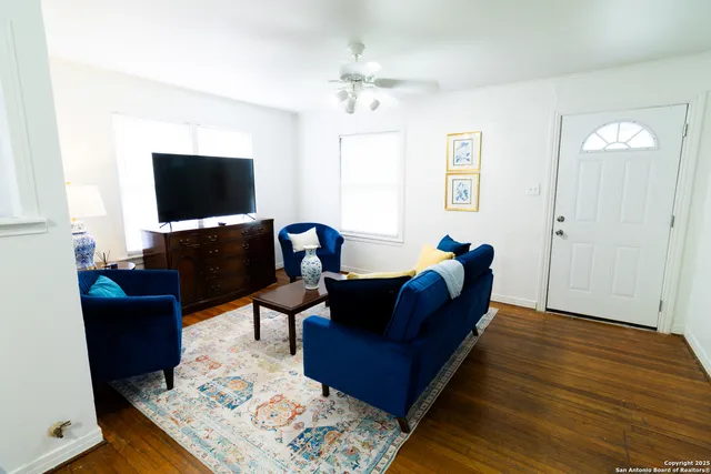 a living room with furniture and a flat screen tv