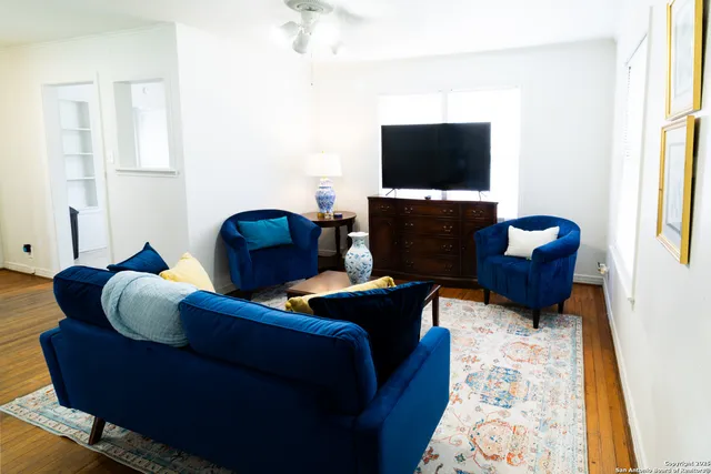 a living room with furniture and a flat screen tv