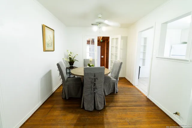 a dining room with furniture and wooden floor