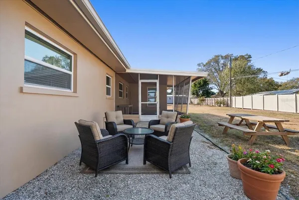 a living room with furniture and a potted plant