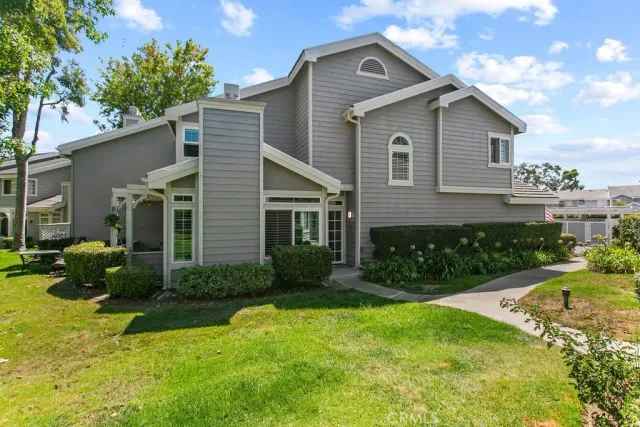 an aerial view of residential house with outdoor space and trees all around