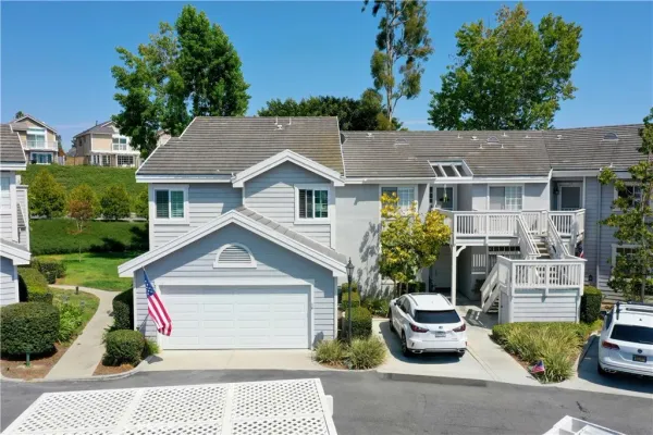 an aerial view of residential house with outdoor space and trees all around