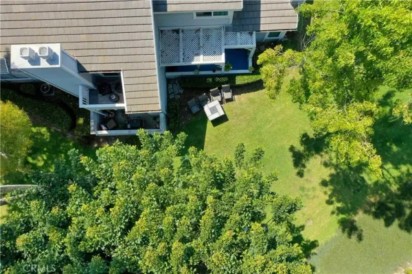 an aerial view of a house with a swimming pool outdoor seating and yard