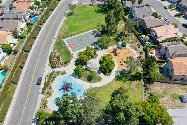 an aerial view of residential house with outdoor space and trees all around
