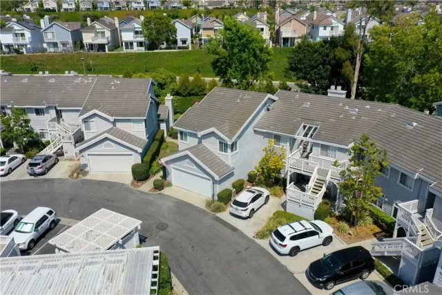 an aerial view of a house with garden space and street view