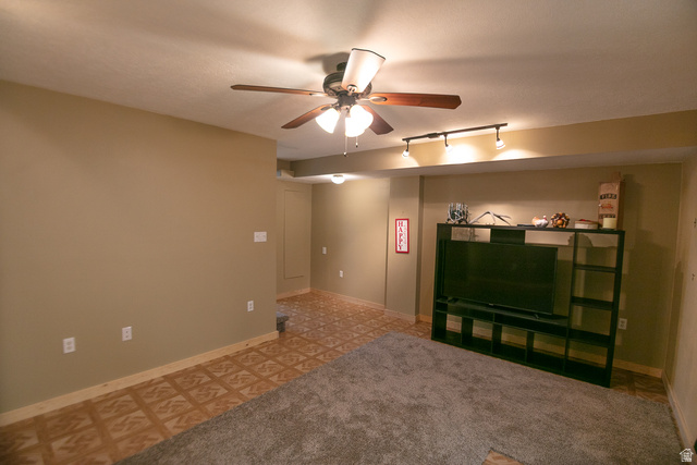 348 North Jakes Pl Road Loa, UT 84747 - Photo 14 of 26 Unfurnished open room featuring track lighting, ceiling fan, and light colored carpet