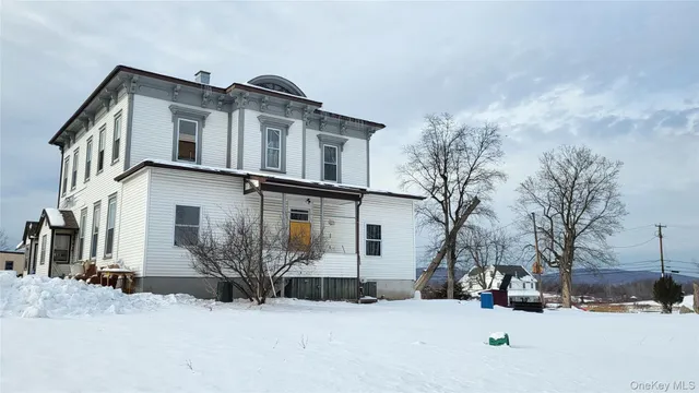 a view of a house with a snow in the yard
