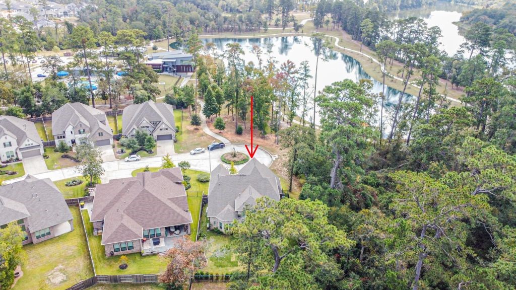 an aerial view of residential houses with outdoor space and swimming pool