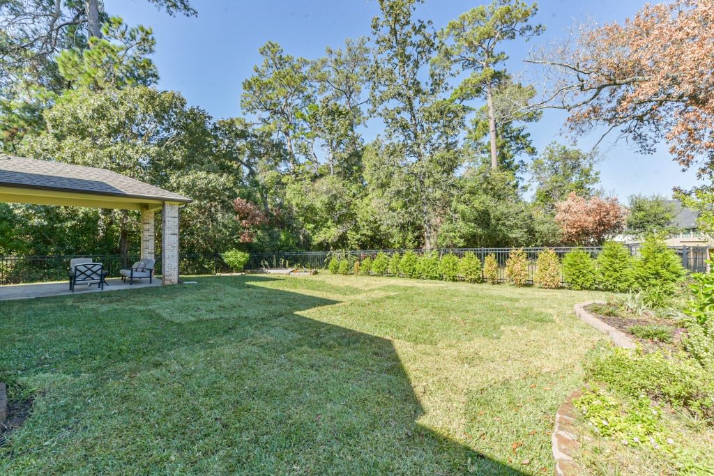 126 Keechie Creek Court Conroe, TX 77304 - Photo 11 of 50 a view of a big yard with large trees