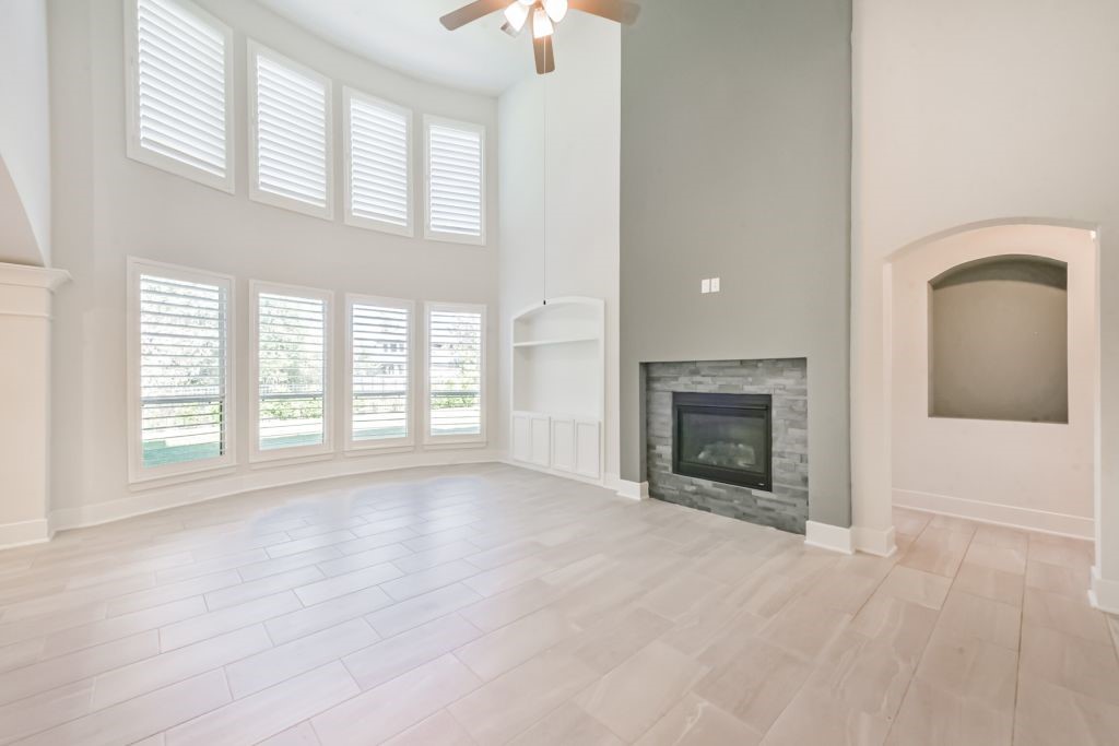 126 Keechie Creek Court Conroe, TX 77304 - Photo 18 of 50 an empty room with windows and fireplace